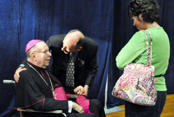 Jackie Byers, left, speaks to Archbishop Emeritus Daniel M. Buechlein after a press conference announcing his retirement on Sept. 21. Byers, a member of St. Simon the Apostle Parish in Indianapolis, is past president of the Archdiocesan Finance Council. Bishop Christopher J. Coyne, right, the archdiocese’s new apostolic administrator, talks with Kevin Rader, a reporter for WTHR Channel 13 in Indianapolis. (Photo by Mary Ann Garber)