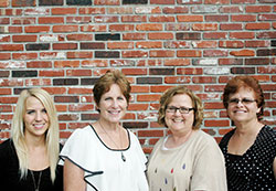 Four Catholic teachers from Indianapolis traveled overseas this summer to lead a workshop for teachers in the African country of Uganda. Erin Ancelet, left, Lynn Baumann, Sharon Ancelet and Nancy Meyer made the three-week journey in July. (Photo by John Shaughnessy)