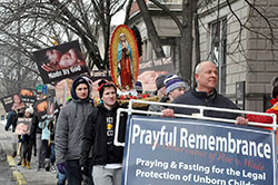 Participants opposing the 1973 Roe v. Wade Supreme Court decision legalizing abortion march along Meridian Street in Indianapolis on Jan. 22, praying aloud and holding signs promoting the dignity of life. (Photo by Natalie Hoefer)